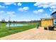 Landscaped backyard with a pond and stamped concrete patio featuring outdoor seating and a pergola at 16683 Alex Dr, Noblesville, IN 46060