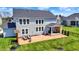 A manicured lawn, cozy outdoor seating and covered porch add charm to this backyard at 16683 Alex Dr, Noblesville, IN 46060
