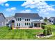 Spacious backyard featuring a well-maintained lawn and a cozy patio area at 16683 Alex Dr, Noblesville, IN 46060