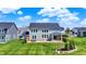 A sprawling green lawn, covered outdoor seating and pergola create an outdoor oasis at 16683 Alex Dr, Noblesville, IN 46060