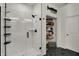 Modern bathroom features a glass shower, black fixtures, and a closet with storage shelves at 16683 Alex Dr, Noblesville, IN 46060