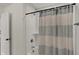 Bathroom featuring a tub with a shower and a gray and white striped shower curtain at 16683 Alex Dr, Noblesville, IN 46060