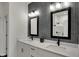 Modern bathroom featuring dual sinks, black fixtures, and a decorative herringbone backsplash at 16683 Alex Dr, Noblesville, IN 46060
