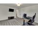 Bedroom with plush carpet, a desk, and a television, perfect for relaxation and entertainment at 16683 Alex Dr, Noblesville, IN 46060