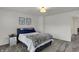 Bedroom featuring soft carpet and a comfortable bed with a cozy blanket and alpaca wall art at 16683 Alex Dr, Noblesville, IN 46060