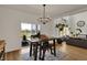 Dining area features wood table, modern chandelier, and water views at 16683 Alex Dr, Noblesville, IN 46060