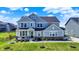 Charming two-story home featuring a covered front porch and well-manicured lawn at 16683 Alex Dr, Noblesville, IN 46060