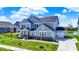 Inviting two-story home with a well-manicured lawn, charming front porch, and attached garage at 16683 Alex Dr, Noblesville, IN 46060