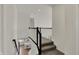 Hallway with carpeted stairs, white walls, and a view of the kitchen at 16683 Alex Dr, Noblesville, IN 46060