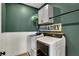 Charming laundry room with modern machines, custom cabinets, and rustic decor elements at 16683 Alex Dr, Noblesville, IN 46060