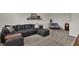 Spacious living room area features a large comfortable sofa, ottoman and plush carpet at 16683 Alex Dr, Noblesville, IN 46060