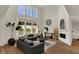Inviting living room with soaring ceilings, large windows, and a cozy fireplace at 16683 Alex Dr, Noblesville, IN 46060