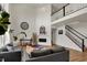 Bright living room with vaulted ceilings, shiplap accent wall, and staircase access at 16683 Alex Dr, Noblesville, IN 46060