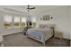 Calming main bedroom features a ceiling fan and a window view of the pond at 16683 Alex Dr, Noblesville, IN 46060