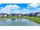 Scenic pond view with water fountain, surrounded by lush green lawn in a serene backyard setting at 16683 Alex Dr, Noblesville, IN 46060