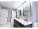 A modern bathroom featuring a double vanity, black hardware, and luxury tile flooring at 1723 Fletcher Ave, Indianapolis, IN 46203