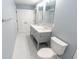This bathroom features a double sink vanity with a quartz countertop and white tiled floors at 1723 Fletcher Ave, Indianapolis, IN 46203