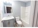 Bathroom featuring modern vanity with countertop, toilet, and tub with shower at 1723 Fletcher Ave, Indianapolis, IN 46203