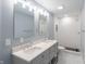 Modern bathroom featuring double sink vanity with marble countertop and white subway tiled shower at 1723 Fletcher Ave, Indianapolis, IN 46203