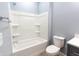 Clean white bathtub and shower combination against soft blue walls creates a calming and functional space at 1723 Fletcher Ave, Indianapolis, IN 46203