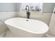Elegant standalone bathtub by a window with matte black fixtures, creating a serene bathroom experience at 1723 Fletcher Ave, Indianapolis, IN 46203