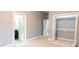 Cozy bedroom with soft grey walls, plush carpet, and doorway leading to bathroom and closet at 1723 Fletcher Ave, Indianapolis, IN 46203