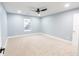 Bright bedroom featuring neutral carpet, blue walls, white trim, and a modern ceiling fan at 1723 Fletcher Ave, Indianapolis, IN 46203