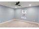 Bright bedroom featuring neutral carpet, blue walls, white trim, and a modern ceiling fan at 1723 Fletcher Ave, Indianapolis, IN 46203