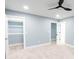 This bedroom boasts neutral carpet, blue walls, trim, closet and doors at 1723 Fletcher Ave, Indianapolis, IN 46203