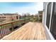 Large wooden deck featuring sleek black metal railings with views of surrounding buildings and lush trees at 1723 Fletcher Ave, Indianapolis, IN 46203