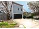 A long driveway leads up to a two-story home with blue siding and a black garage door at 1723 Fletcher Ave, Indianapolis, IN 46203