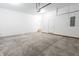 Spacious garage with bright lighting, multiple doors and concrete flooring at 1723 Fletcher Ave, Indianapolis, IN 46203