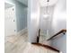 Well-lit hallway featuring light wood floors, white doors, and neutral walls, connecting various rooms of the home at 1723 Fletcher Ave, Indianapolis, IN 46203