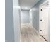 Hallway with wood-look floors, blue walls, and doors at 1723 Fletcher Ave, Indianapolis, IN 46203