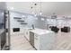 Spacious kitchen with island, stainless steel appliances, and open layout to the living area with gray furniture at 1723 Fletcher Ave, Indianapolis, IN 46203