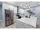 Bright kitchen with white cabinets, stainless steel appliances, and a spacious island with quartz countertops at 1723 Fletcher Ave, Indianapolis, IN 46203