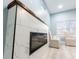Modern fireplace with white marble surround and wood mantel, complemented by stylish seating at 1723 Fletcher Ave, Indianapolis, IN 46203