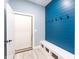 Mudroom area features a bright blue accent wall with hooks and bench seating at 1723 Fletcher Ave, Indianapolis, IN 46203