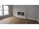 Bright living room featuring a modern fireplace, trim, and a large window with lots of natural light at 17458 Ebling Trl, Westfield, IN 46062