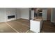 Spacious living area with a modern electric fireplace and under-cabinet lighting in a neutral color palette at 17458 Ebling Trl, Westfield, IN 46062
