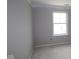 Clean bedroom with gray walls and bright window, awaiting personal touches to complete the space at 17458 Ebling Trl, Westfield, IN 46062