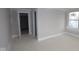 Unfinished bedroom features neutral walls, white trim, and natural light from a window, awaiting personalization at 17466 Ebling Trl, Westfield, IN 46062