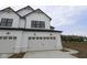 Newly constructed modern farmhouse featuring white siding, a black roof, and two-car garage with a concrete driveway at 17466 Ebling Trl, Westfield, IN 46062