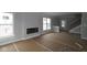 Bright living room features large windows, a modern fireplace, staircase, and is ready for personalized finishing touches at 17466 Ebling Trl, Westfield, IN 46062