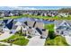 An aerial view of a neighborhood with a pond and fountain surrounded by well-maintained homes at 180 Oakhurst Way, Westfield, IN 46074