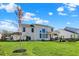 Spacious backyard features manicured lawn, large trees and a white home exterior, ideal for entertaining at 180 Oakhurst Way, Westfield, IN 46074
