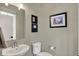 Powder room with pedestal sink, toilet, and decorative artwork at 180 Oakhurst Way, Westfield, IN 46074