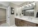 Modern bathroom features a double sink vanity, large mirror, and walk-in shower with unique tile at 180 Oakhurst Way, Westfield, IN 46074