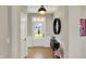 Bright foyer with hardwood floors, modern light fixture, and neutral wall color at 180 Oakhurst Way, Westfield, IN 46074