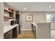 Kitchenette area features stainless steel appliances, wooden cabinets, and natural light at 180 Oakhurst Way, Westfield, IN 46074